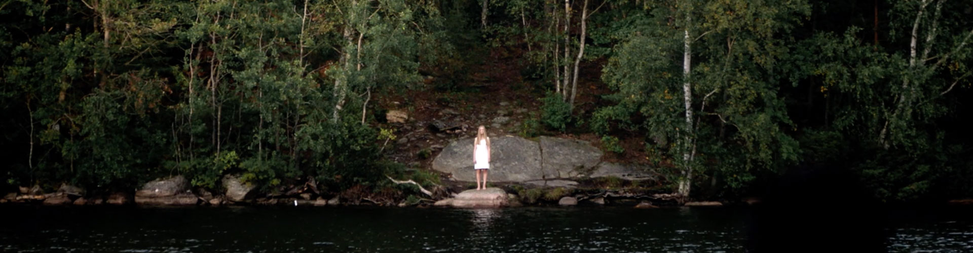 woman standing at lake